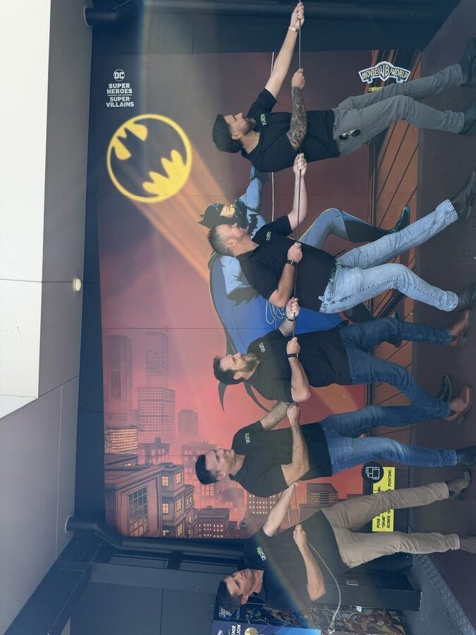 The grolife team climbing a building Batman-style at Movie World